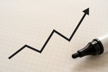 arrow up on white paper with marker.