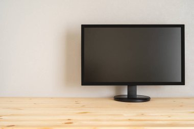 A black display on the wooden table.