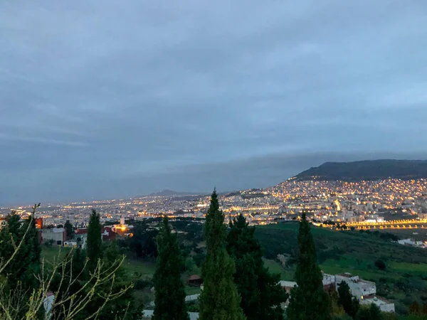 Breathtaking top view of the city shrouded in a mesmerizing and mystical foggy evening