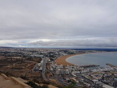 Agadir 'in nefes kesici güzelliğine dalıp Agadir Oufella' ın tüm şehir manzarasını gösteren büyüleyici bir fotoğrafla kendinizi gösterin. Bu büyüleyici görüntü bu sahil taşının özünü yakalar ve tüm şehrin panoramik manzarasını ortaya çıkarır. Azu.