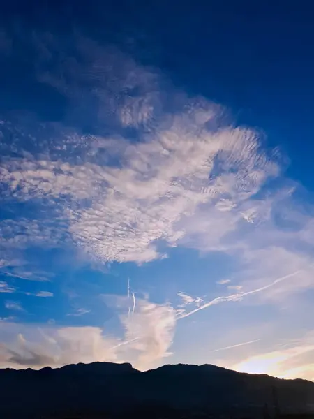 stock image Skyscape embraces clouds in vibrant colors, the vibrant horizon of cloud dance, and looks at these amazing panorama where the horizon adopts the dance of clouds from the endless sky.