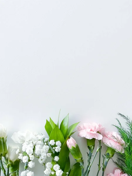 stock image Close up photo of a bouquet of pink and white carnations isolated on a white background. With empty space for text or inscription. For postcard, advertisement or website.