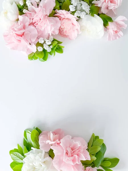 stock image Border frame made of pink and white carnations flower on white background. Flat lay, top view. Flowers frame.