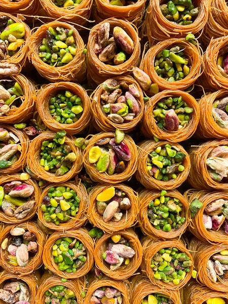 Oriental sweets close-up. Baklava with pistachios, walnuts, almonds. Photo for puzzles.