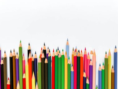 Assorted colored pencils lined up on white background with space for text. Creative concept for art, education, and design advertising banner for school products with empty space. High quality photo clipart