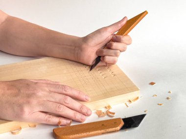 Precision woodcarving techniques. Hands crafting intricate patterns on wood. clipart