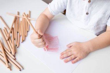 Beyaz kağıda renkli kalemlerle çocuk çizimi.