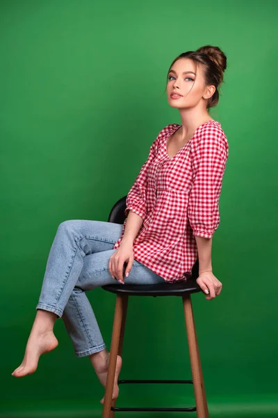 Pretty Young Girl Checkered Shirt Jeans Posing Chair Green Background — Stock Photo, Image