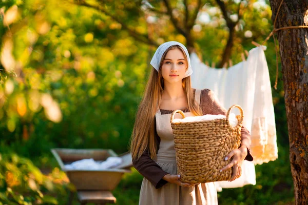 中世の衣装でかなり若いランドレス村の自然の上に古い谷でドレスを洗う 田舎で働く美しい女の子 おとぎ話の作品 — ストック写真