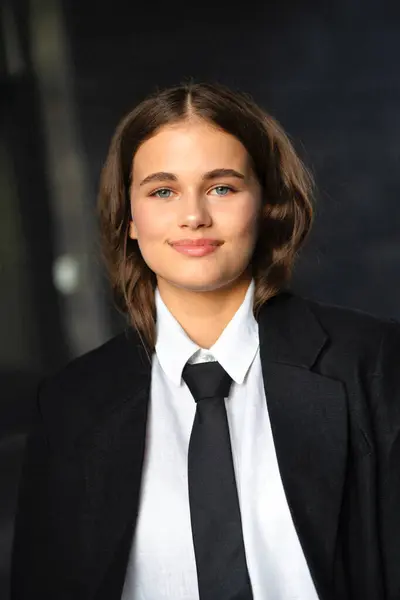 stock image Beautiful teenager girl posing on streets wearing jacket and tie dress. Young model on photo in business style.