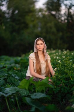 Kız yazın bahçede çalışıyor.