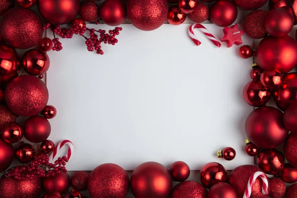 stock image Framing of red Christmas balls of different sizes and textures on a white background, copy space