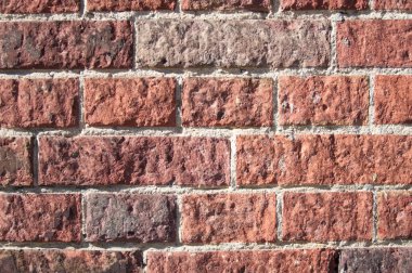Textured red color brick wall background closeup. High quality photo