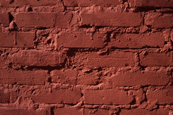 Textured red color brick wall background closeup. High quality photo