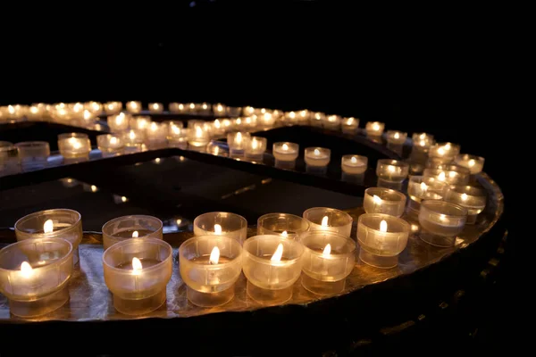 stock image Burning candles on a round stand in the church. High quality photo