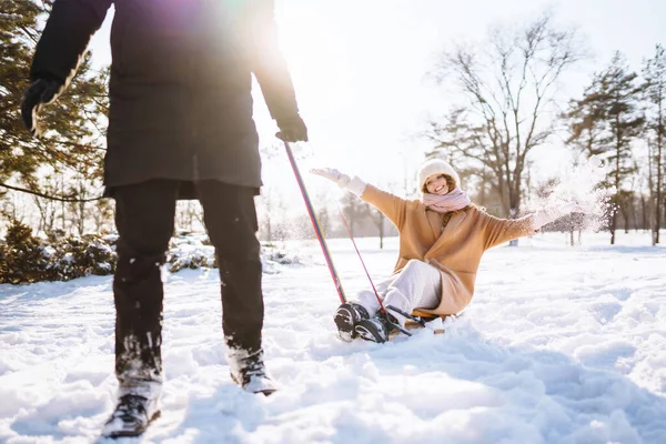 Man Rolls Woman Sled Winter Snowy Forest Cold Weather Holidays — Stock Photo, Image