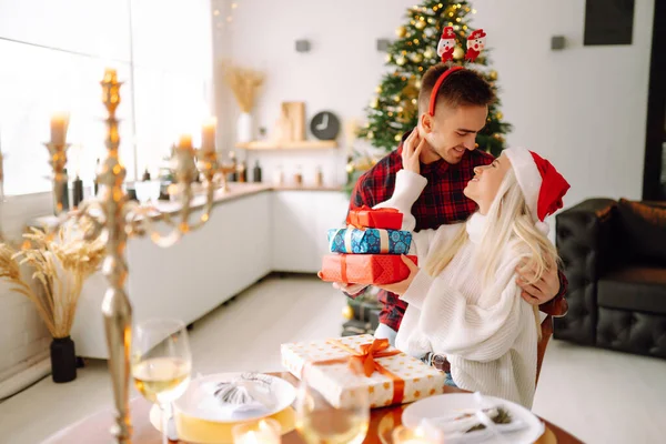 Young couple have Christmas surprise for holiday. Romantic day. Winter holidays.