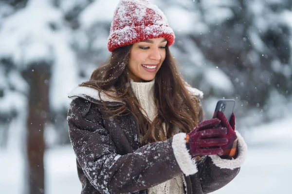 stock image Young woman taking selfie in winter forest. Holidays, rest, travel concept.