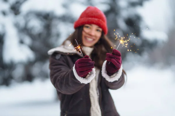 クリスマスは手に輝きます 冬の森で輝きを保持している陽気な若い女性クリスマス — ストック写真