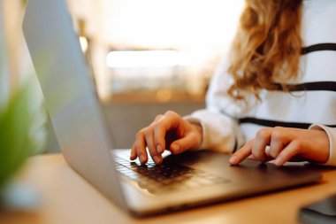 Close- up picture of female hands working on her laptop. Social networking technology concept. Technology, Freelance, online course, remote work and lifestyle concept