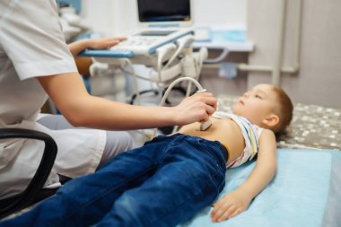 Little boy undergoing ultrasound at clinic.  hild's health.