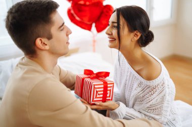 Hediye değişimi. Evde Sevgililer Günü 'nü kutlayan genç bir çift. Birlikte romantik bir gün..