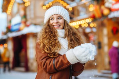 A pretty woman walks around the fair at Christmas. Travelling, lifestyle, adventure, holidays concept.