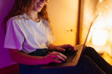 Young woman working online or studying sitting at home office, late at night. Business, blogging, freelance, Online shopping, education concept.