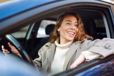 Young woman drive a car. Automobile journey, traveling, lifestyle concept. Car sharing.