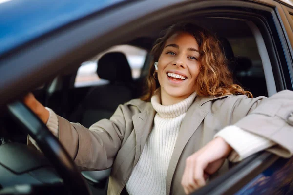 Young woman drive a car. Automobile journey, traveling, lifestyle concept. Car sharing.