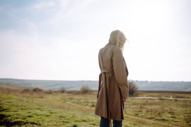 Young woman enjoys a spring sunny day. Spring girl. People, travel, nature concept.