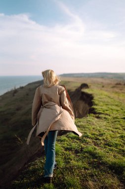 Young woman enjoys a spring sunny day. Spring girl. People, travel, nature concept.