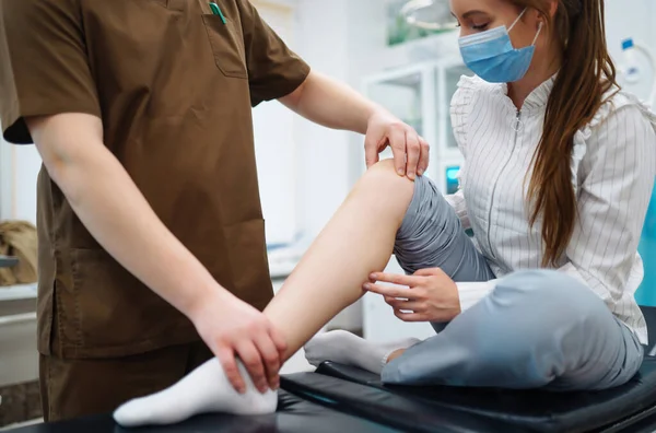 Doctor Examining Female Patient Injured Leg Osteopathy Chiropractic Leg Adjustment — Stock Photo, Image