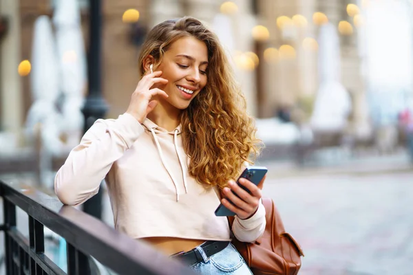 stock image Photo of a woman using smart phone. Beautiful woman texting on the street. Beautiful woman spending time in the city. 