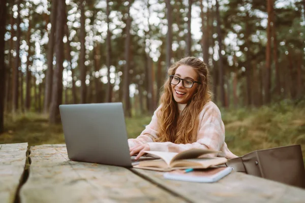Young woman with laptop outdoor. Education online. Freelancer, Business, shopping, blogging, online video conference.