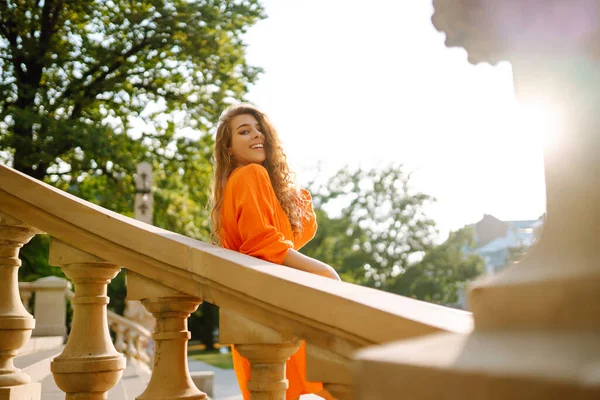 Красивая Молодая Женщина Позирует Фоне Городского Пейзажа Ярко Оранжевом Платье — стоковое фото