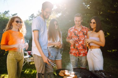 Ompany 'deki insanlar yaz parkında bbq partisi veriyor. Arkadaşlar et pişirir, eğlenir, rahatlar. Yaşam tarzı, tatiller, hafta sonları ve boş zaman dışında. Piknik ve barbekü.