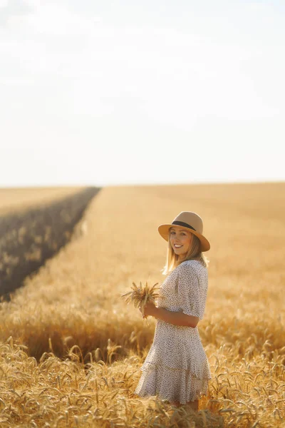 Stylish woman enjoying nature in the field. Lifestyle, travel, tourism, nature, active life.