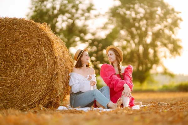 Två Kvinnor Poserar Ett Vetefält Nära Höbalar Natur Semester Avkoppling — Stockfoto
