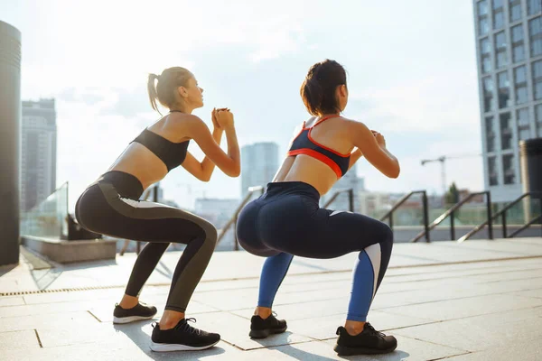 stock image Two women in sportive clothes have fitness day outdoors together. Sport, Active life, sports training, healthy lifestyle.