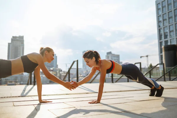 stock image Two women in sportive clothes have fitness day outdoors together. Sport, Active life, sports training, healthy lifestyle.