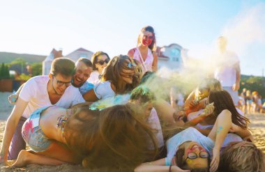 Renkli kıyafetleri ve vücutları olan neşeli genç arkadaşlar Holi Festivali 'nde size iyi eğlenceler. Plaj partisi. Arkadaşlık, dinlenme, tatil.