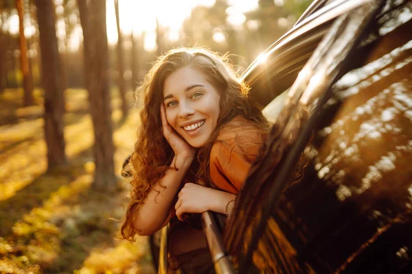 在美丽阳光明媚的夏日路上感受自由 在开车的时候被一个漂亮的女人从车窗里探了出来 积极的生活方式 — 图库照片