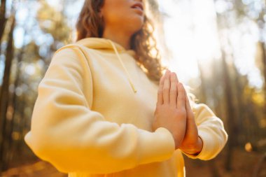 Güzel bir kadın sonbahar ormanında yoga yapıyor. Yaşam tarzı ve meditasyon konsepti.