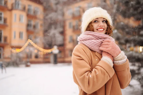 一个甜美的女人沿着装饰过的街道走着 卷曲的女人享受着降雪 寒假在户外 假日概念 — 图库照片
