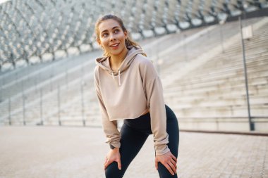 Açık havada egzersiz yapan zinde bir kadın. Sağlıklı genç bayan sporcu spor yapıyor. Aktif yaşam tarzı konsepti, spor.