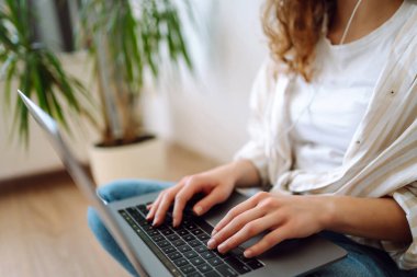 Dizüstü bilgisayarda klavye üzerinde çalışan ellerin yakın çekimi. Kadın müşterinin e-postasına cevap veriyor, alıcı çevrimiçi mağaza hizmetlerini kullanarak internetten satın alıyor. İnternet ve modern kablosuz teknolojileri kullanma kavramı