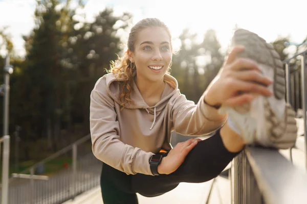 Young woman with smart watch goes in for sports, performs sport exercises. Sport, Active life, sports training, healthy lifestyle.