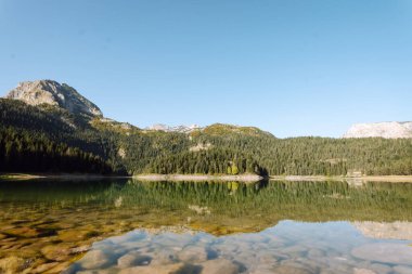 Göl manzarası çok güzel. Sabah Dağ Gölü 'nün kayalık kıyısı. Seyahat, yaşam tarzı, vahşi doğa konsepti. Seyahat için ünlü bir yer.