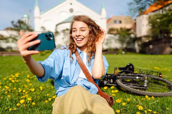 Young Woman Lays Grass Bike Takes Selfie Smartphone Travel Weekend Stock Image